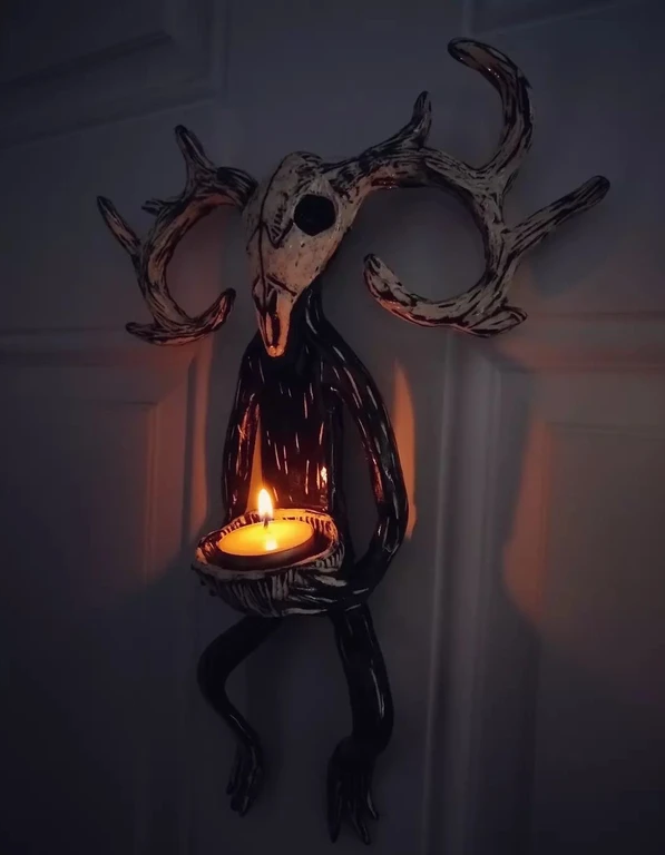 Deer Skull Sculpture, 2022, Ceramic, this hanging sculpture holds a tealight candle. It is inspired by the skulls & antlers my younger brother would bring home from exploring in the woods.